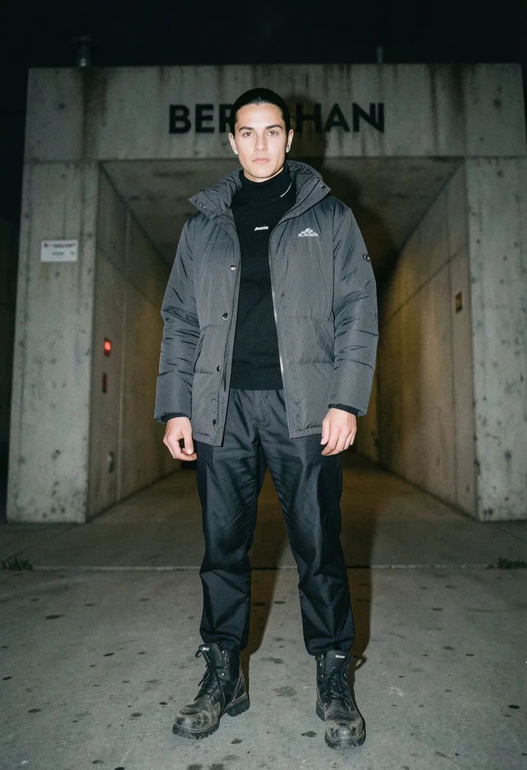 34-year-old gender-nonconforming East-European DJ with calm, observant intensity